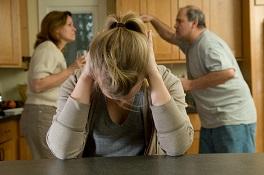 Child covering ears from fight